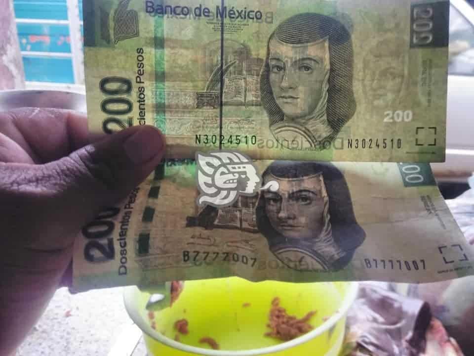 Alertan comerciantes por circulación de billetes falsos