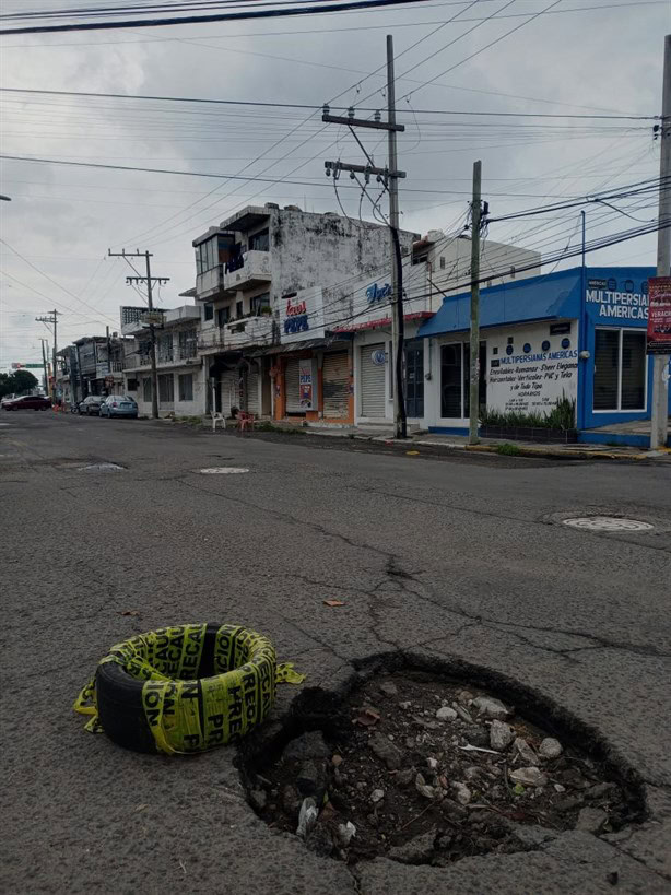 Lluvias provocan aparición de baches en Veracruz; ciudadanos los marcan con objetos