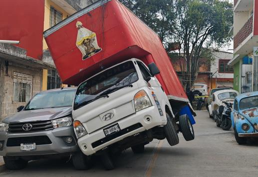 Camioneta queda recargada sobre otra tras jalar cables eléctricos en Xalapa